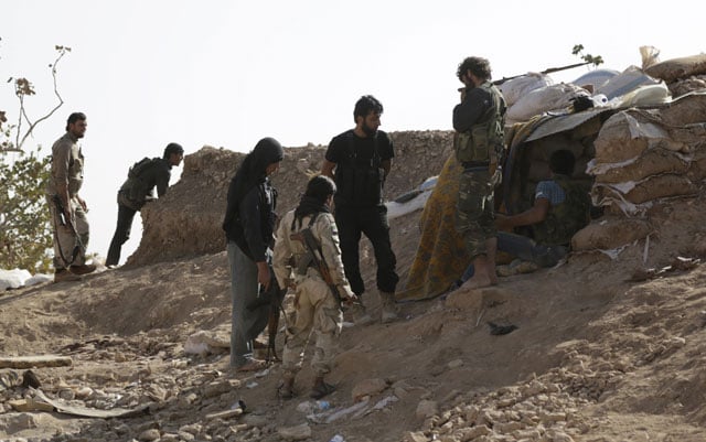 free syrian army fighters of the 101 division stand behind sandbags near the town of morek in the northern countryside of hama syria on october 14 2015 photo reuters