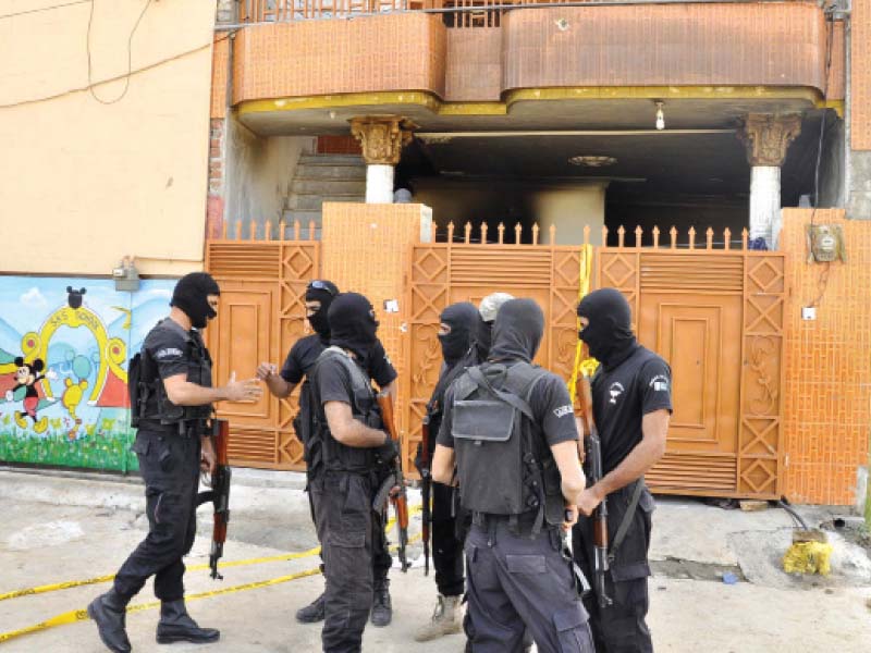 policemen gathered outside the raided house photos agha mehroz express