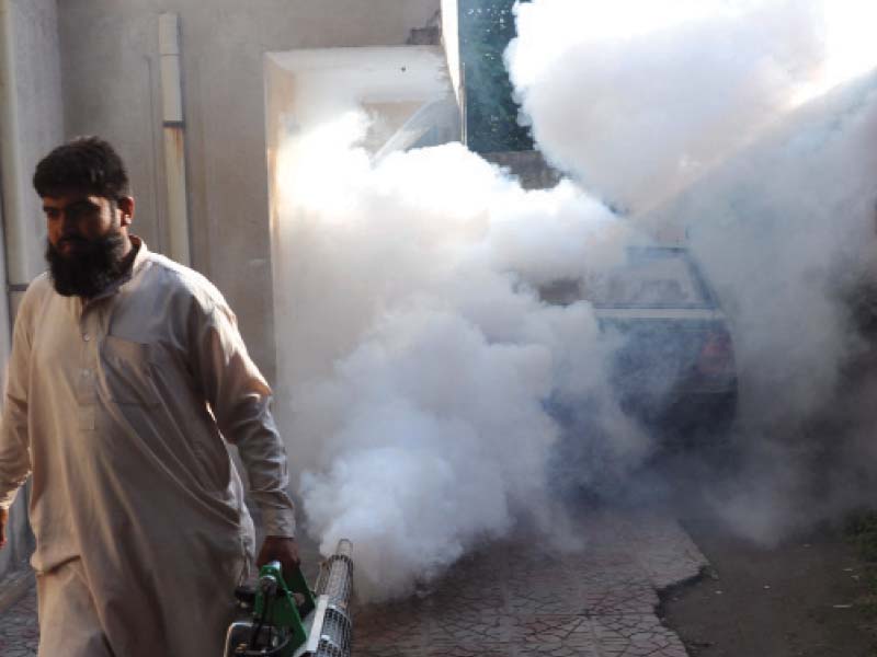 a health department official undertaking anti dengue spray in saddar rawalpindi photo zafar aslam express