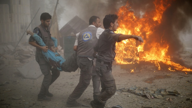 syrian emergency personnel carry a wounded man following air strikes by syrian government forces on a marketplace in the rebel held area of douma east of the capital damascus on october 11 photo afp