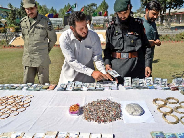 gold and foreign currency confiscated from militants during a search operation photo muhammad iqbal express gold and foreign currency confiscated from militants during a search operation photo muhammad iqbal express