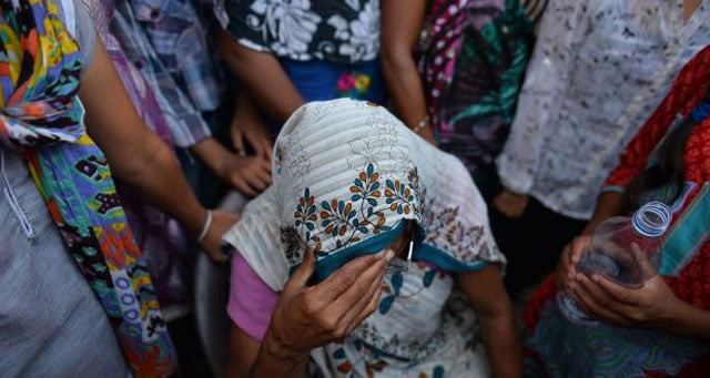 the grandmother of a girl who was raped sits among protesters near the child s home in new delhi photograph chandan khanna photo afp