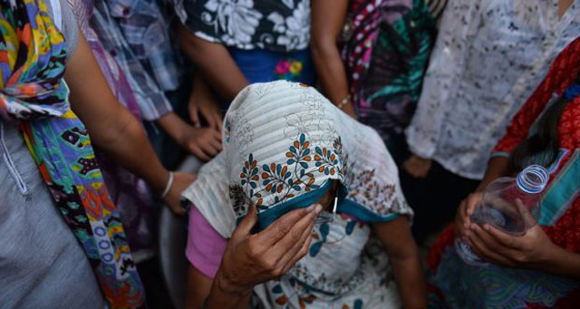 the grandmother of a girl who was raped sits among protesters near the child s home in new delhi photograph chandan khanna photo afp