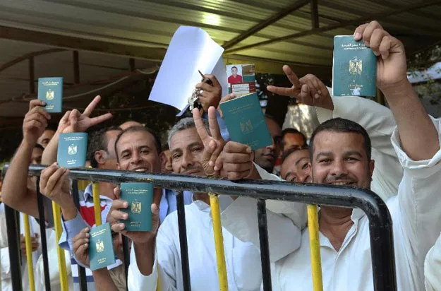 egyptian nationals living in kuwait show their passports as they wait to cast their vote on the eve of the egyptian parliamentary elections on october 17 2015 outside their embassy in kuwait city photo afp egyptian nationals living in kuwait show their passports as they wait to cast their vote on the eve of the egyptian parliamentary elections on october 17 2015 outside their embassy in kuwait city photo afp