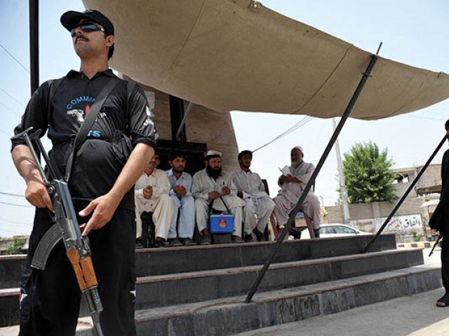 in this file photo a police commando guards a polio vaccination team photo afp