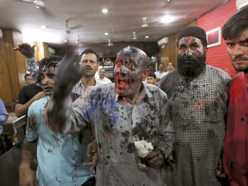 kashmiri lawmaker engineer rashid with his face smeared in black paint thrown by the activists from hindu sena talks to the media in new delhi photo reuters