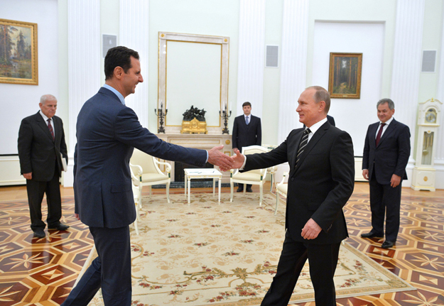 russian president vladimir putin r greets his syrian counterpart bashar al assad l during a meeting at the kremlin in moscow on october 20 2015 photo afp