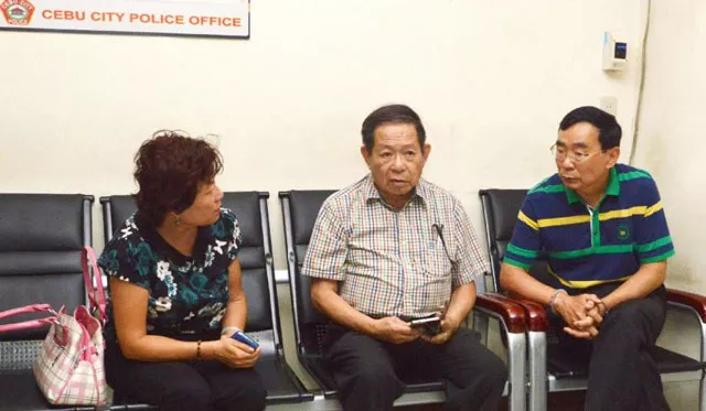 a chinese consular officer left and her hand cuffed husband right will return to china after being held in the philippines for the shooting of chinese consul general song ronghua photo afp a chinese consular officer left and her hand cuffed husband right will return to china after being held in the philippines for the shooting of chinese consul general song ronghua photo afp