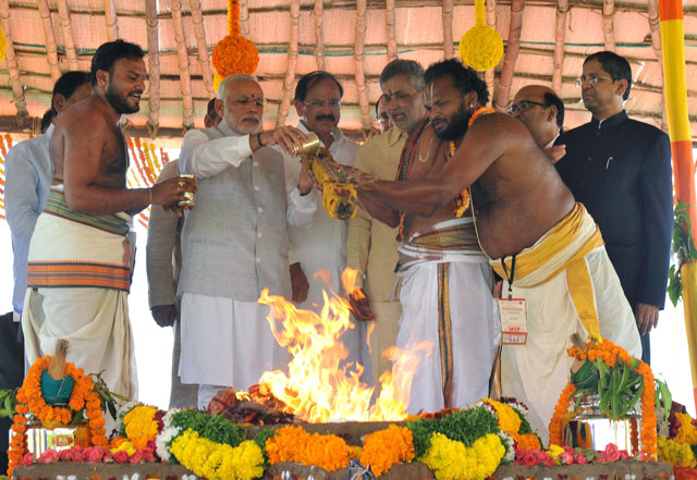 in this handout photograph released by the indian press information bureau pib on october 22 2015 indian prime minister narendra modi 2nd l performs a pooja ritual at the foundation stone laying ceremony in amaravati the new capital of andhra pradesh photo afp