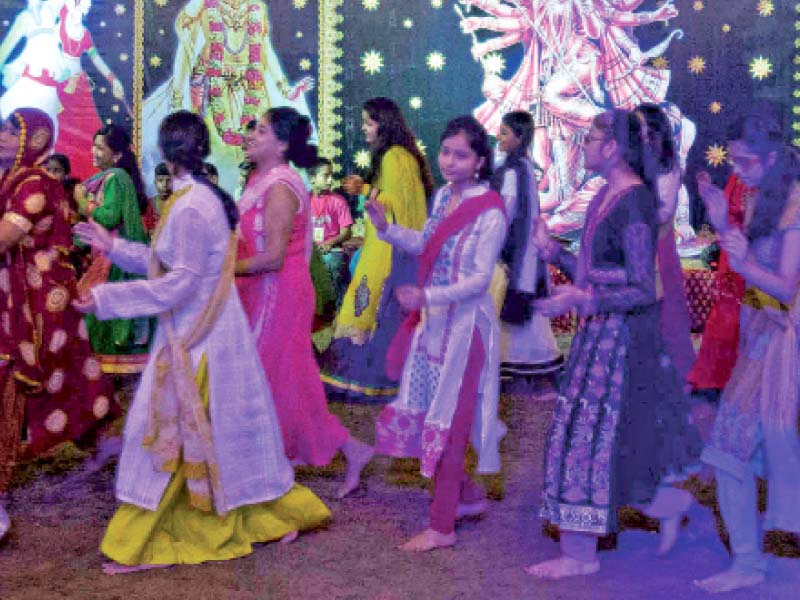 members of the hindu community partake in the traditional dandiya dance on the eve of dussehra which marks the end of navratri at the swami narayan mandir on tuesday night photo athar khan express