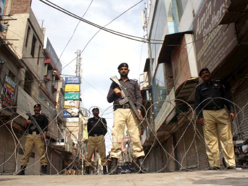 policemen stand on guard in anarkali photo abid nawaz express