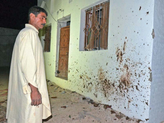 a man looks at a blood stained wall in chalgari balochistan photo afp a man looks at a blood stained wall in chalgari balochistan photo afp