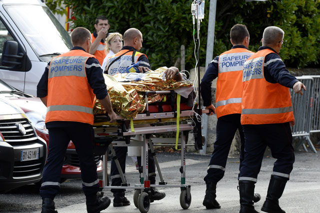 emergency services personnel take away an injured person from the site of a collision on october 23 2015 in puisseguin near libourne southwestern france photo afp