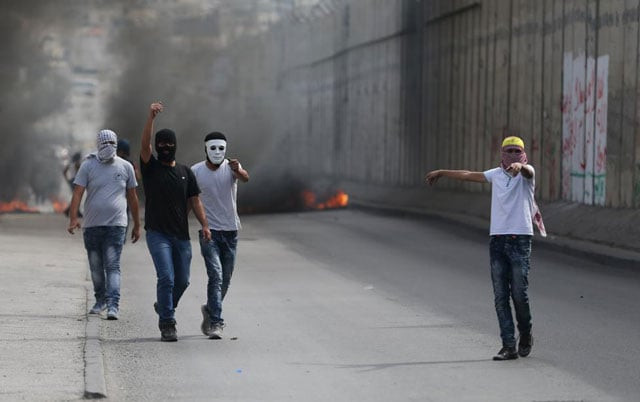 palestinian protesters gesture during clashes with the israeli troops in the west bank town of al ram near jerusalem october 22 2015 photo reuters palestinian protesters gesture during clashes with the israeli troops in the west bank town of al ram near jerusalem october 22 2015 photo reuters
