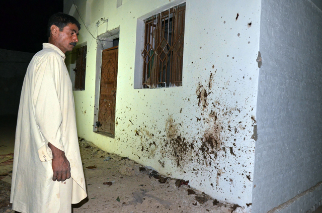 a man looks at the site of a suicide bomb attack at a mosque in the town of chalgari in restive baluchistan some 170 kilometres southeast of quetta on october 22 2015 photo afp