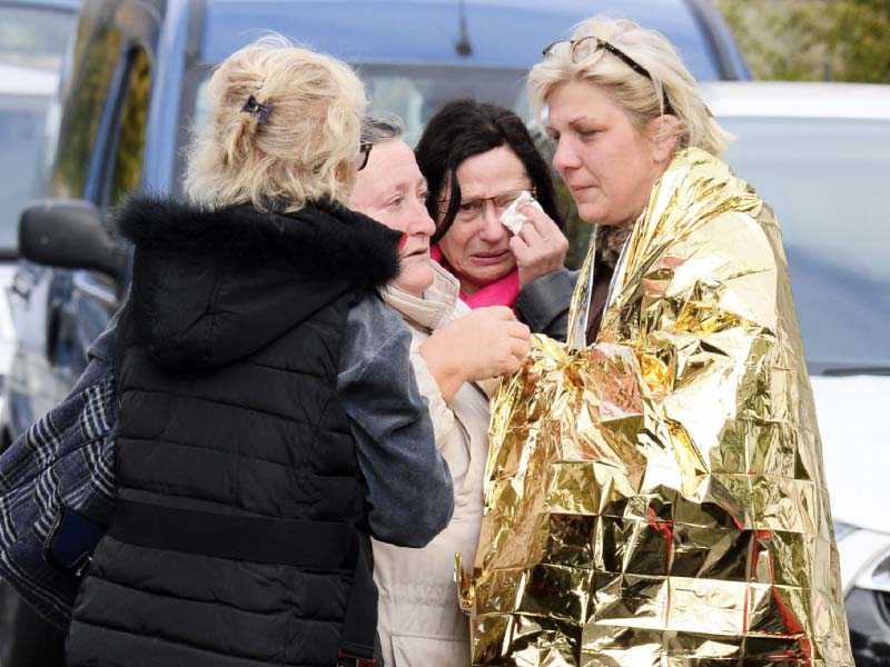 people comfort a survivor at the site of the collision in puisseguin southwestern france photo afp