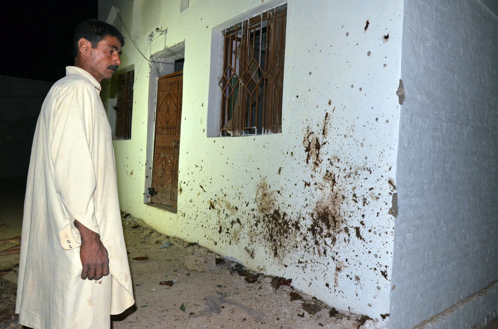 a man looks at the site of a suicide bomb attack at a mosque in the town of chalgari baluchistan on october 22 2015 photo afp