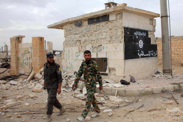 syrian government forces walk past a building bearing an image on the wall with islamic writing and reading in arabic the quot islamic state quot in the village of jabboul on the eastern outskirts of the northern syrian city of aleppo after taking control of the village from islamic state is group islamists on october 24 2015 photo afp syrian government forces walk past a building bearing an image on the wall with islamic writing and reading in arabic the quot islamic state quot in the village of jabboul on the eastern outskirts of the northern syrian city of aleppo after taking control of the village from islamic state is group islamists on october 24 2015 photo afp