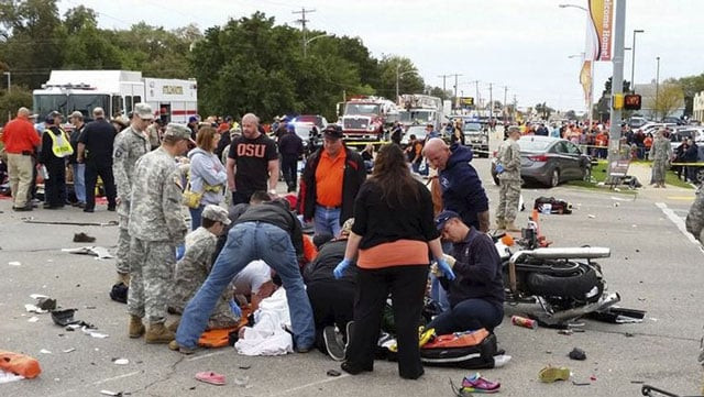 people attend to the injured at the scene of a car crash after a car drove into a homecoming parade at oklahoma state university in stillwater oklahoma on october 24 2015 photo reuters people attend to the injured at the scene of a car crash after a car drove into a homecoming parade at oklahoma state university in stillwater oklahoma on october 24 2015 photo reuters