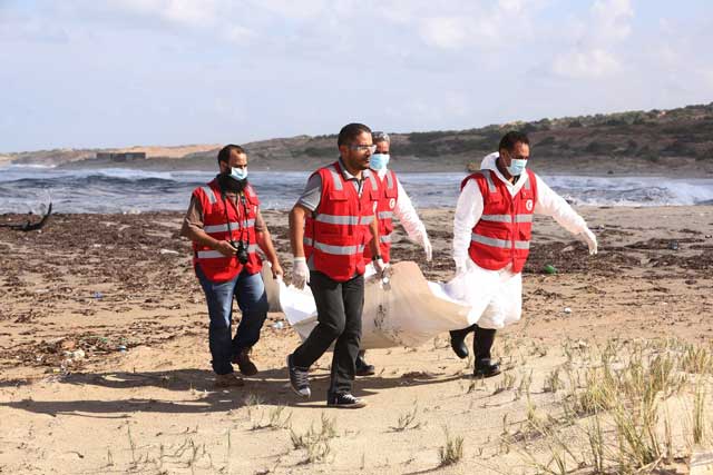 libyan red crescent personnel work on recovering the bodies of 14 people thought to be migrants that were discovered on a beach near khoms some 120 kms east of tripoli on october 25 2015 the bodies of at least 43 people have washed up on libyan beaches east of the capital tripoli at the weekend the red crescent said photo afp
