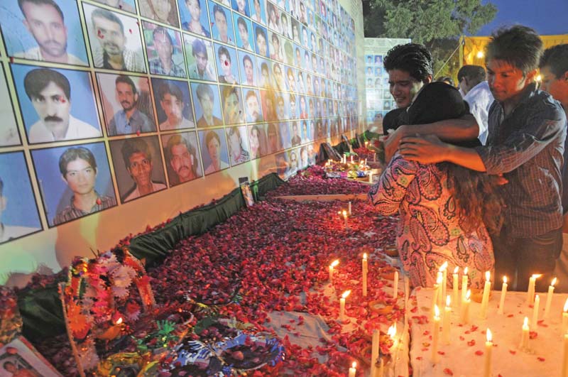 relatives of the baldia factory fire victims hold a vigil in remembrance of their loved ones photo file