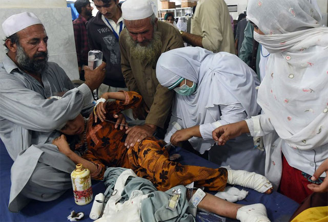 paramedics treat a girl injured in an earthquake at a hospital in peshawar on october 26 2015 photo afp