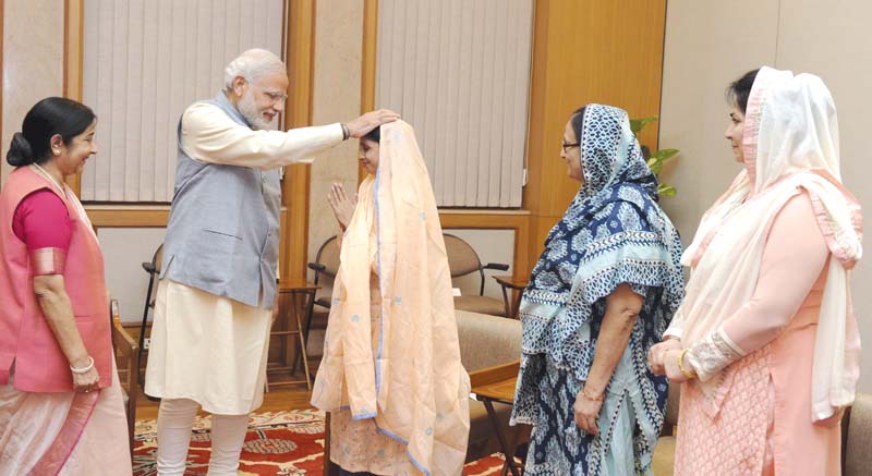 indian prime minister narendra modi gives blessings to geeta in new delhi as foreign minister sushma swaraj and others look on photo reuters