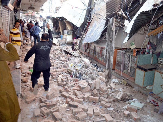 residents gather at a damaged market following an earthquake in sargodha photo afp residents gather at a damaged market following an earthquake in sargodha photo afp