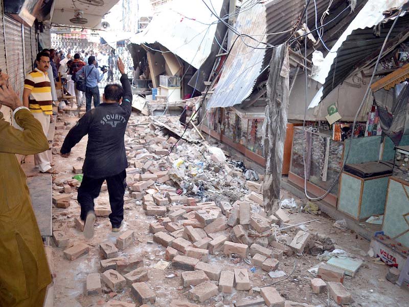 residents gather at a damaged market following an earthquake in sargodha photo afp