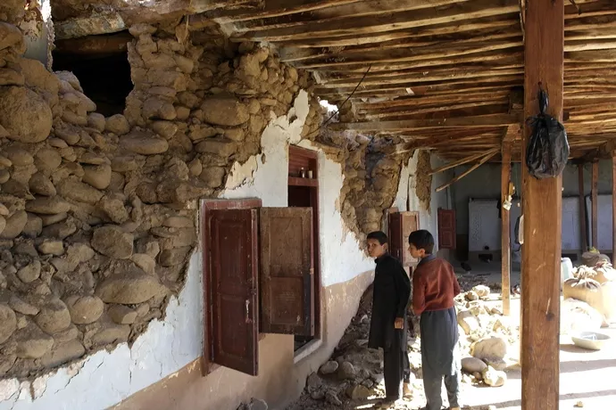 young children look at a damaged house following an earthquake in lower dir on october 27 2015 photo afp young children look at a damaged house following an earthquake in lower dir on october 27 2015 photo afp