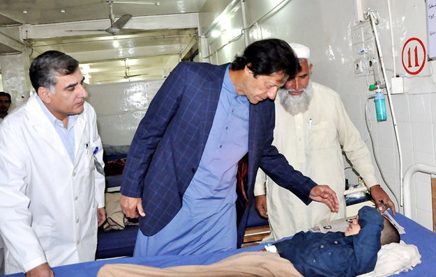 chairman pti imran khan inquiring about the health of injured persons of earthquake during his visit to lrh photo nni