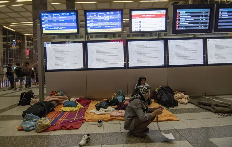 migrants sit at the far end of a platform at vienna 039 s train station westbahnhof in vienna on september 13 2015 photo afp migrants sit at the far end of a platform at vienna 039 s train station westbahnhof in vienna on september 13 2015 photo afp