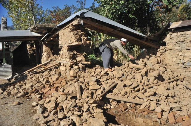 an earthquake survivor removes rubble from his collapsed house in earthquake hit lower dir on october 28 2015 photo afp an earthquake survivor removes rubble from his collapsed house in earthquake hit lower dir on october 28 2015 photo afp