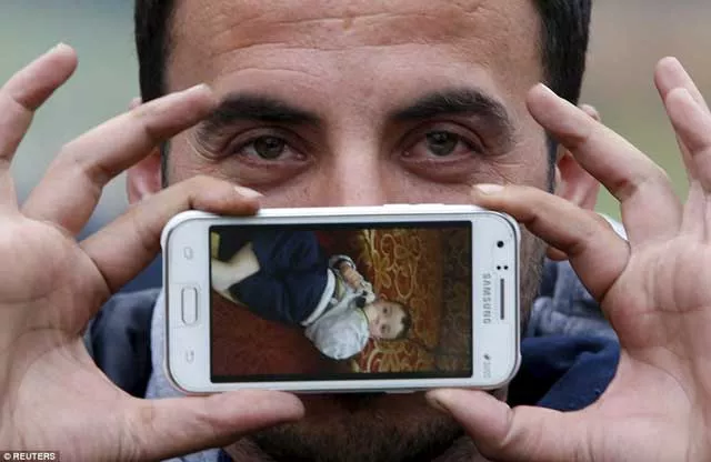 sirad from zabadani syria displays a picture of his son jad on his samsung phone as he waits and hopes to cross the border into austria photo reuters sirad from zabadani syria displays a picture of his son jad on his samsung phone as he waits and hopes to cross the border into austria photo reuters