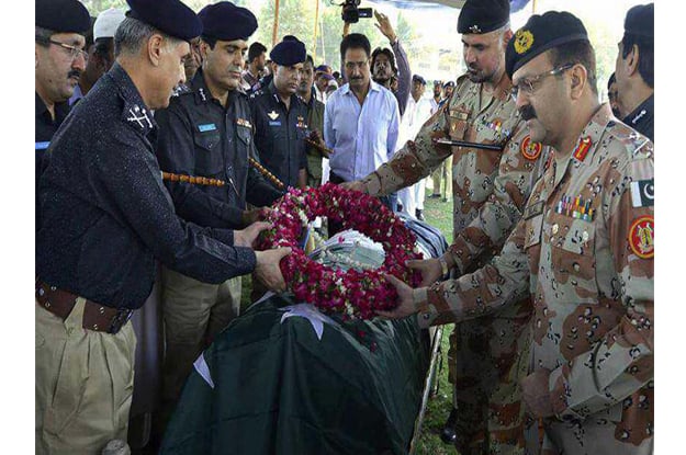 rangers director general major general bilal akbar and sindh ig ghulam hyder jamali are placing wreath on funeral of martyred policemen in karachi on wednesday photo ppi