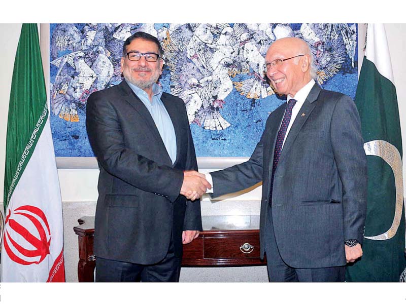 ali shamkhani and sartaj aziz shake hands prior to their meeting at the foreign office photo app