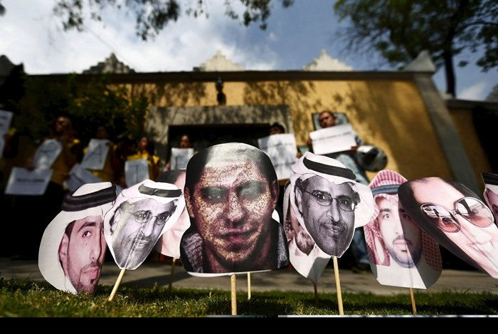 saudi blogger raif badawi c is seen between other photos of prisoners in saudi arabia during a demonstration for his release from jail outside the embassy of saudi arabia in mexico city in february 20 2015 photo reuters