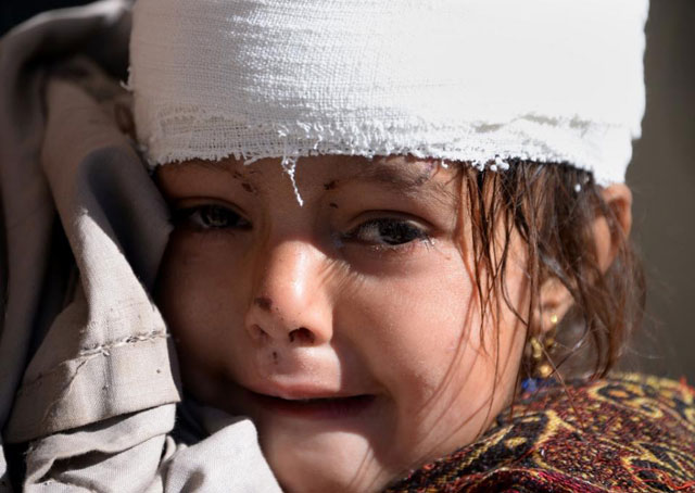 a young girl weeps at a hospital in quake hit shangla pakistan on october 28 2015 photo afp
