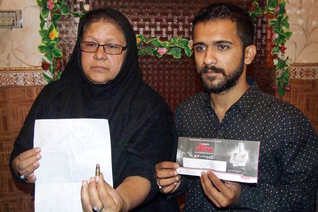 leader of pti syeda tasneem zohra and his son showing a threatening letter with a bullet mailed by unknown persons on october 28 2015 photo online leader of pti syeda tasneem zohra and his son showing a threatening letter with a bullet mailed by unknown persons on october 28 2015 photo online
