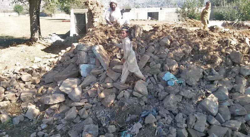 a boys stand on the debris of a house in salarzai bajaur agency photo express