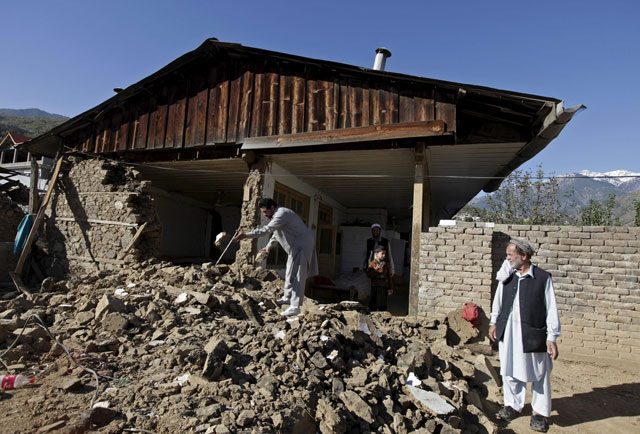 a man clears the rubble of the house of 50 year old herbal healer najib alam whose mud and stone house was damaged by the 7 5 magnitude quake in rehankot village in district dir on october 28 2015 photo reuters