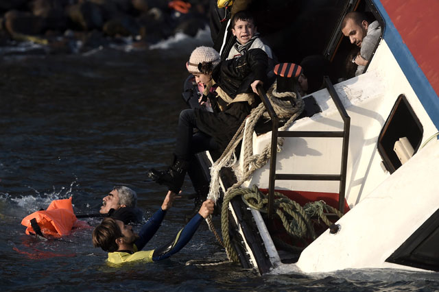 a young boy cries out for help with other refugees and migrants as their boat sinks off the greek island of lesbos island while crossing the aegean sea from turkey on october 30 2015 photo afp