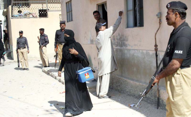 a lady health worker carries her polio vaccines while on duty in orangi town policemen stand guard to avert any untoward incident photo file a lady health worker carries her polio vaccines while on duty in orangi town policemen stand guard to avert any untoward incident photo file