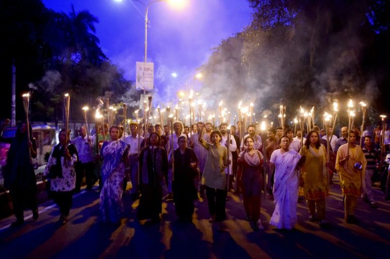 bangladeshi activists take part in a torch lit protest against the killing of a blogger in dhaka on august 8 2015 photo afp