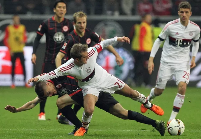 philipp lahm c and aleksandar ignjovski l vie for the ball during the bundesliga football match in frankfurt am main western germany on october 30 2015 photo afp philipp lahm c and aleksandar ignjovski l vie for the ball during the bundesliga football match in frankfurt am main western germany on october 30 2015 photo afp