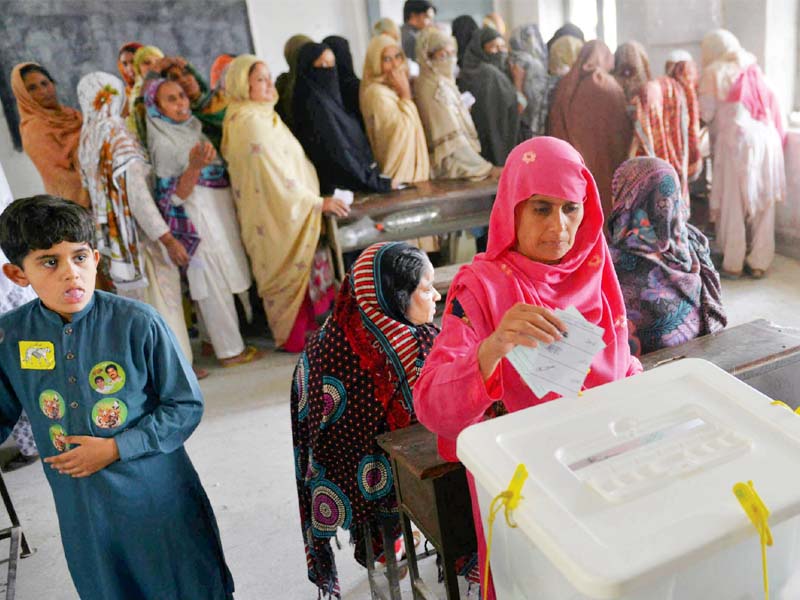 a woman casts her vote at a polling station in a punjab village photo waseem niaz express