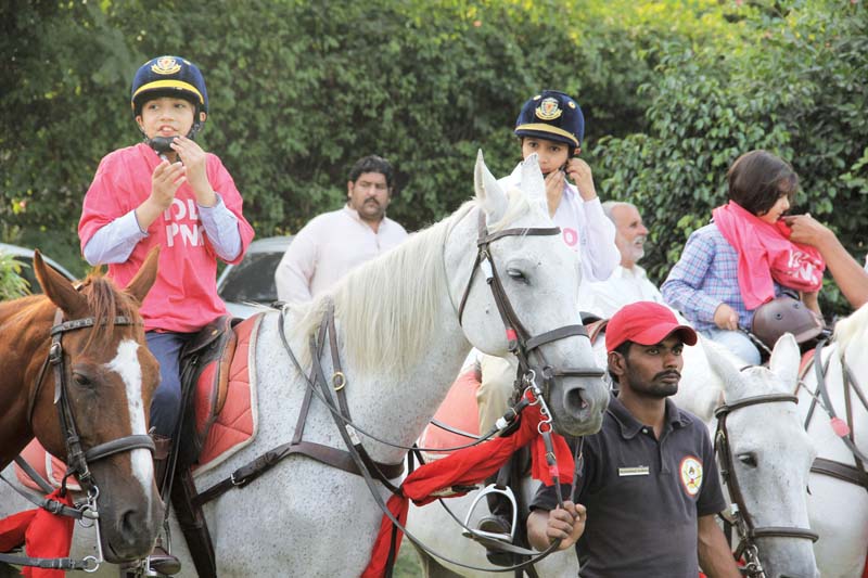 children sporting pink shirts rode horses at polo ground to raise awareness about breat cancer photo ayesha mir express