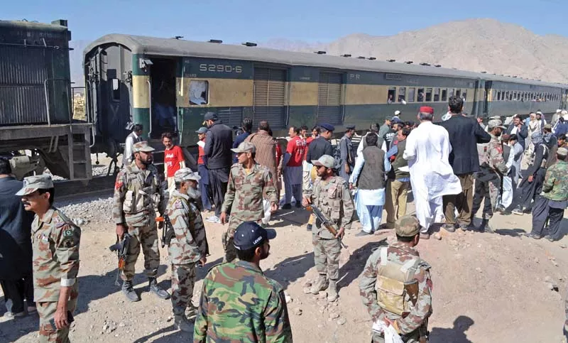 security officials stand next to a compartment of the train hit by an ied blast in mastung photo afp security officials stand next to a compartment of the train hit by an ied blast in mastung photo afp