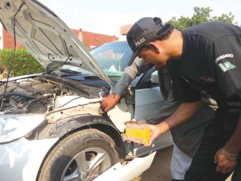 cops examining one of the cars photo tariq ismaeel