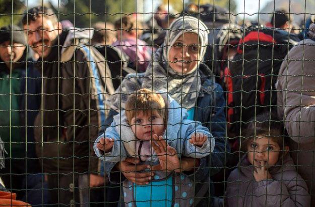 refugees and migrants wait to cross the slovenian austrian border from the slovenian city of sentilj on november 3 2015 photo afp